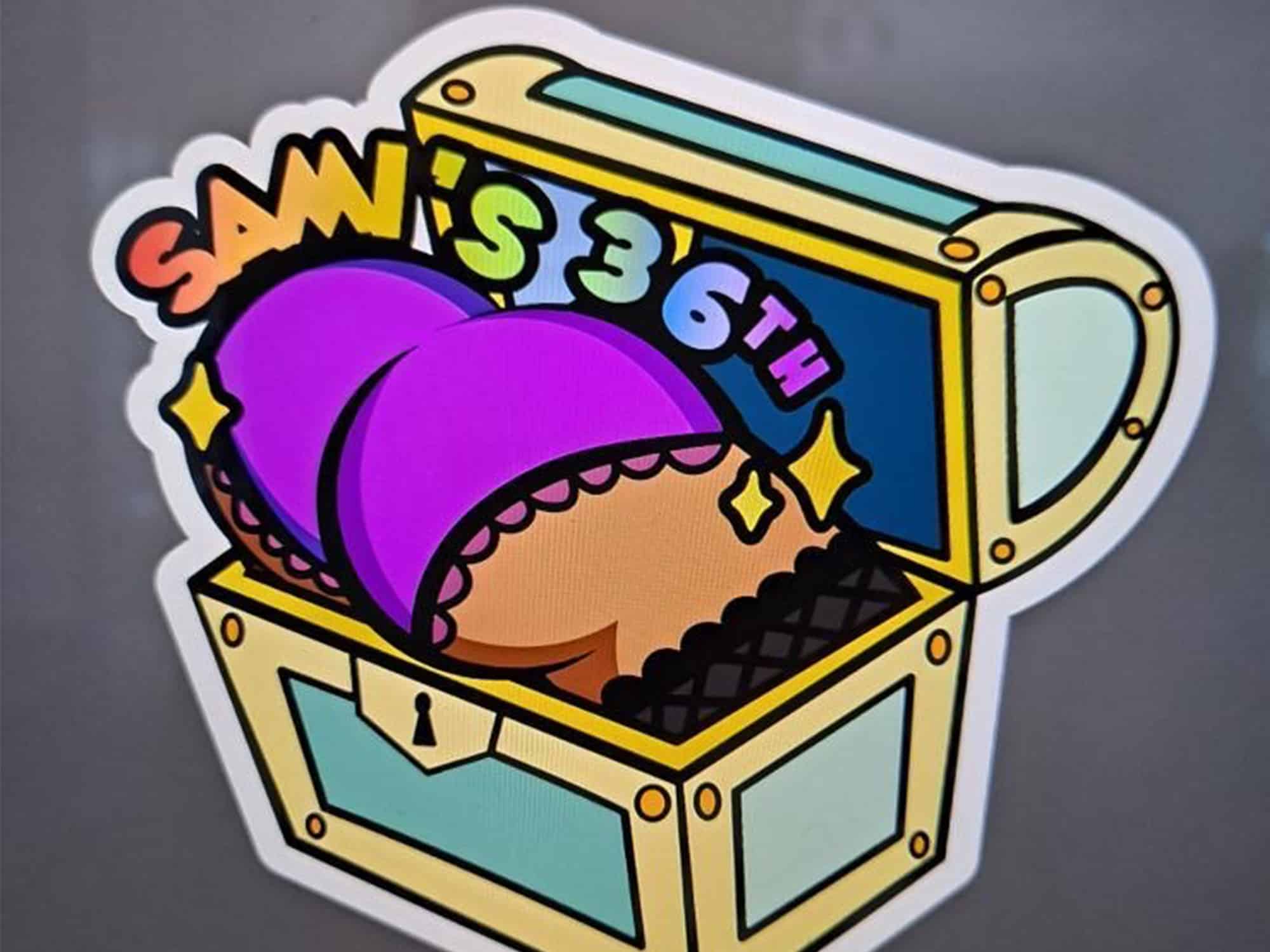 A custom-designed sticker for the author's birthday party shows a human butt, clad in purple underwear, emerging from a treasure chest. Sticker designed by Carlos of BloopMerch.