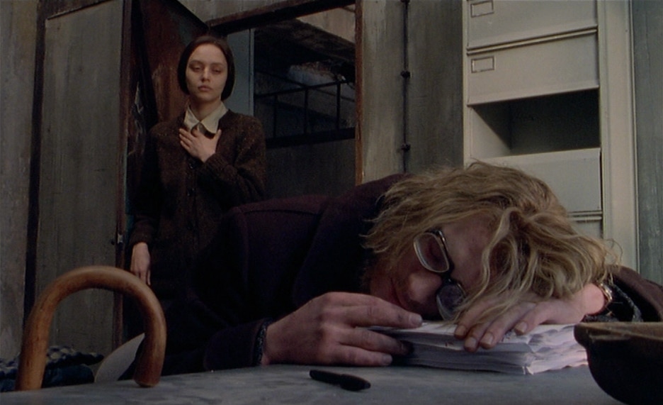 Mysterious half-sister Isabelle (Yekaterina Golubeva) slowly walks in on a disheveled and bespectacled Pierre (Guillaume Depardieu, in the foreground), who's sleeping on a ream of papers at his desk—the origins of a new novel devoted to uncovering truths.