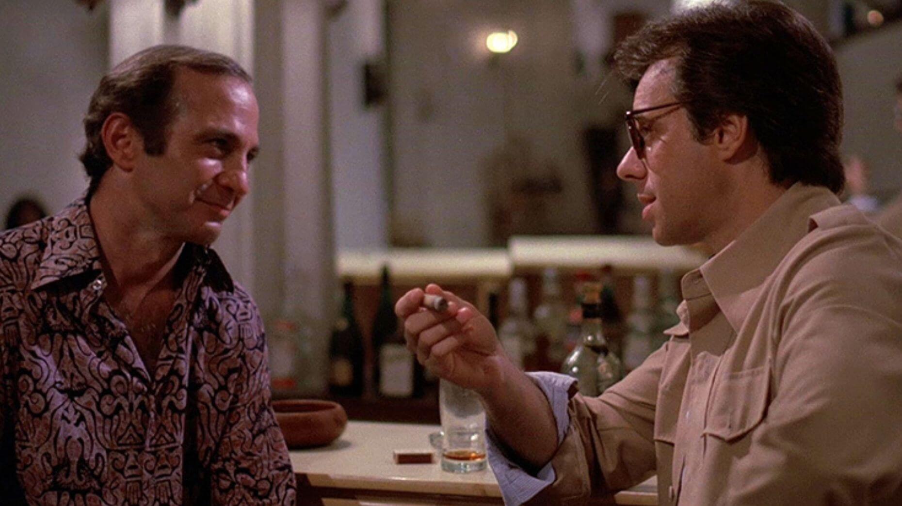 The titular Jack (Ben Gazarra, left) talks things over with the shady Eddie Schuman (director Peter Bogdanovich, right) in a scene from "Saint Jack."