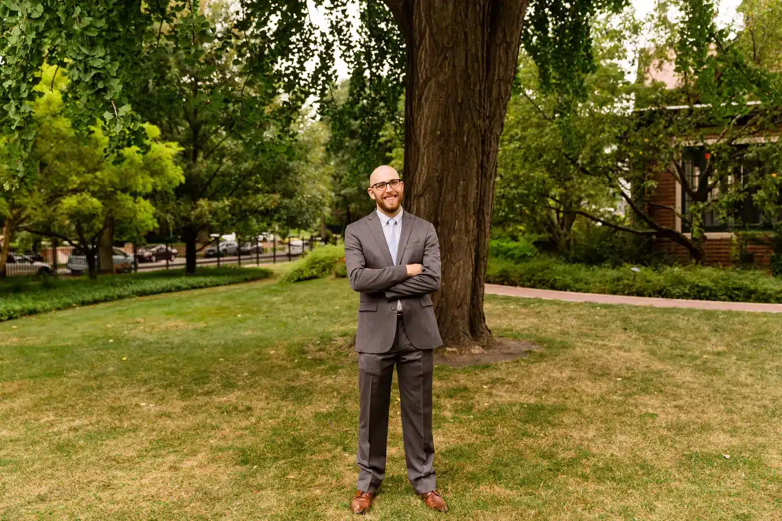 Musician Ethan Philion is shown posing for a publicity photo outdoors, with a tree in the background.