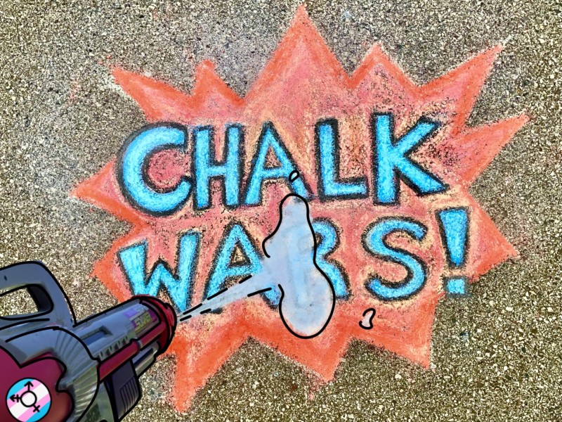 Illustration by M.Rose Sweetnam. [Image description: written in chalk on concrete are the words “CHALK WARS!” The words are drawn over a comic style explosion. In perspective standing above the chalk drawing is a super soaker spraying the image with water. On the super soaker is the trans symbol with the trans flag in the background. End image description]
