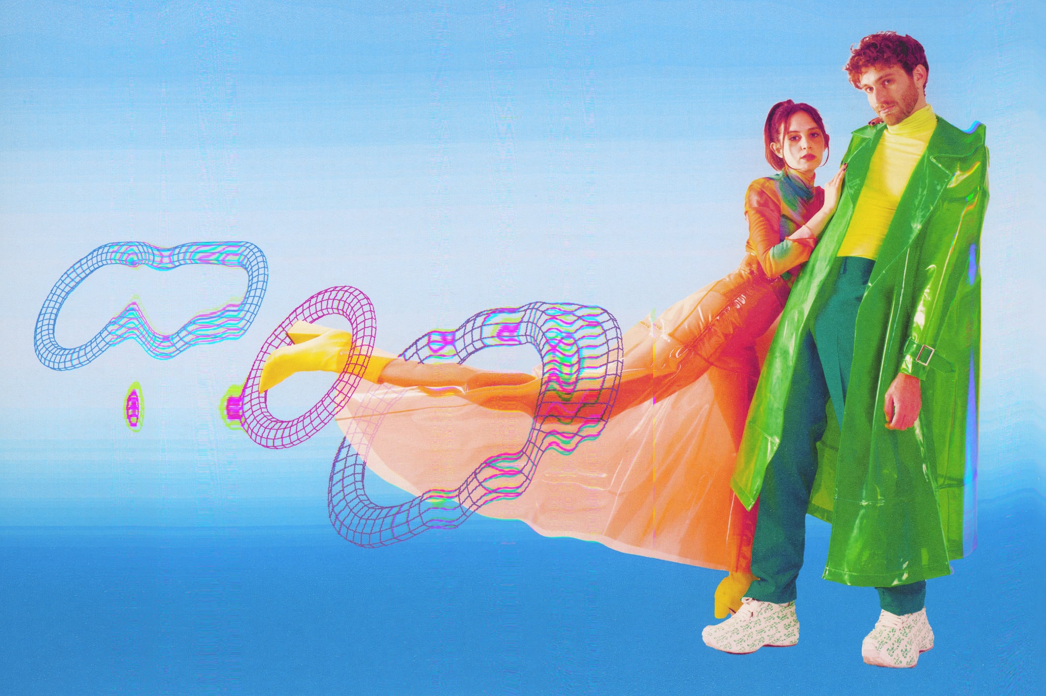 Magdalena Bay (Mica Tenenbaum and Matthew Lewin) pose in colorful outfits against a sky blue background in this digitally enhanced promotional photo by Lissyelle Laricchia.