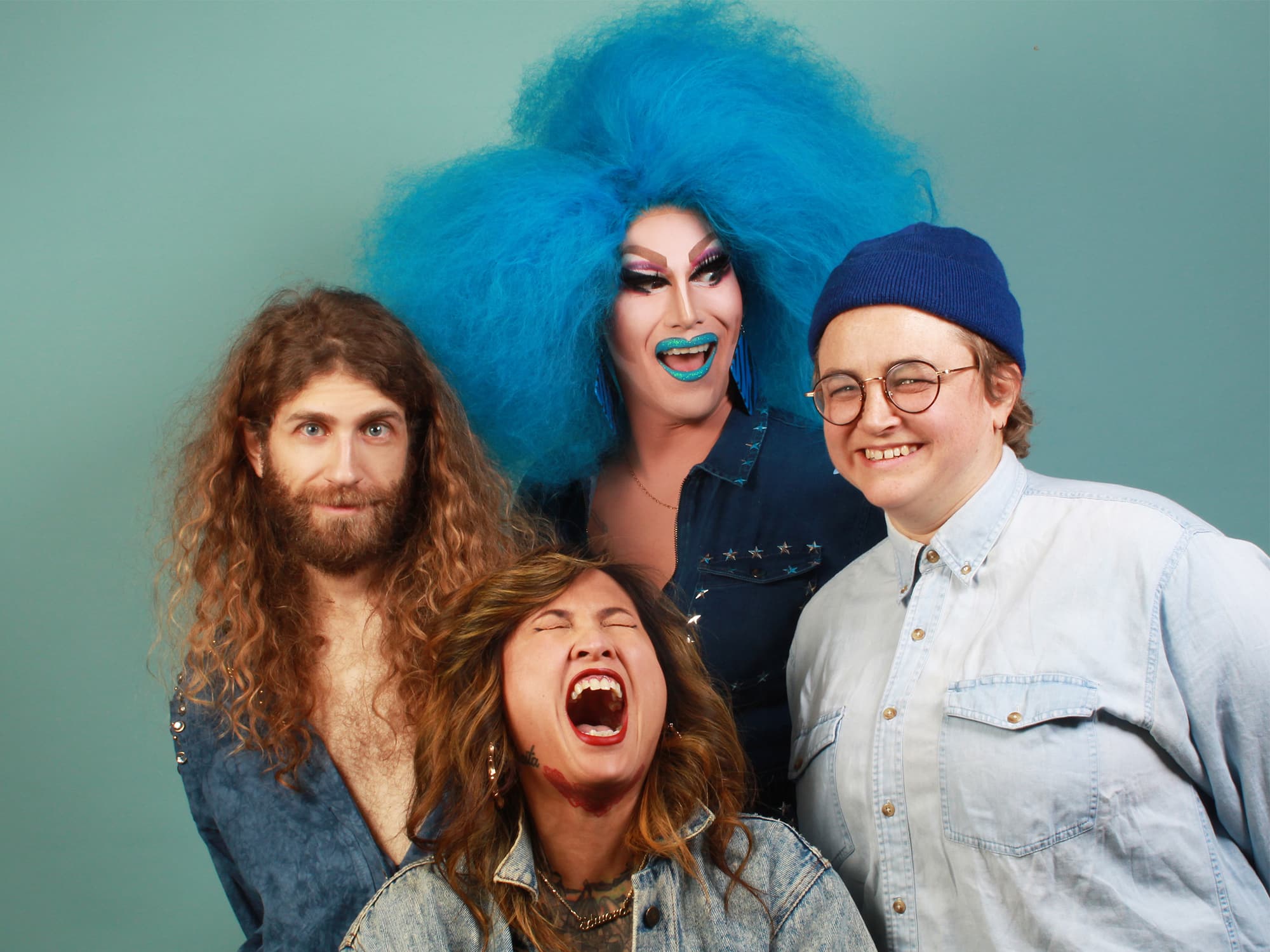 A publicity photo shows four members of the band Bev Rage & The Drinks posing against a blue-green background.
