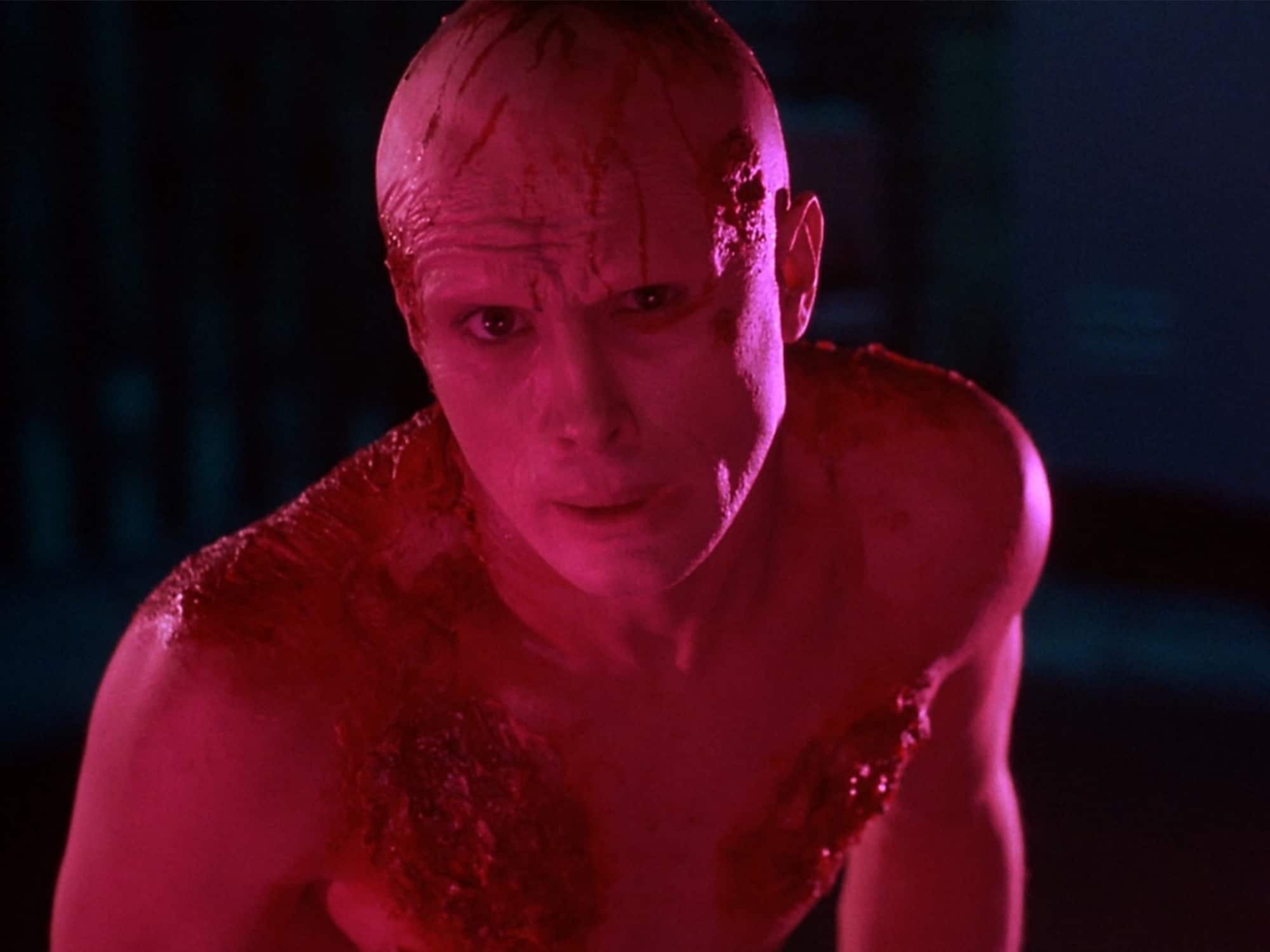 Actor Jeffrey Combs is shown in a mutated, glowing-pink form in the film From Beyond.