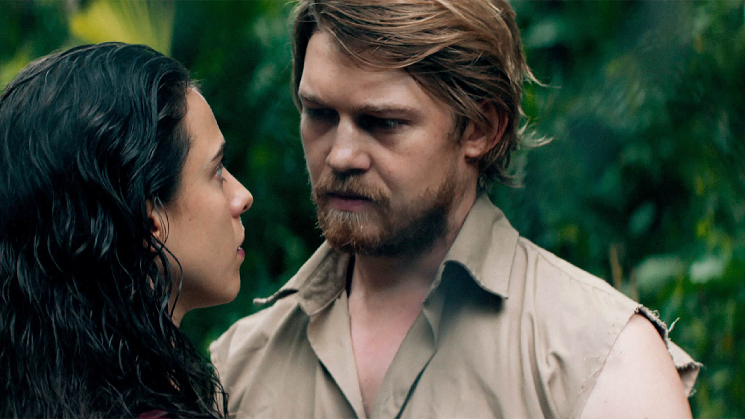 Trish Johnson (Margaret Qualley) and Daniel DeHaven (Joe Alwyn) stare at each other longingly.