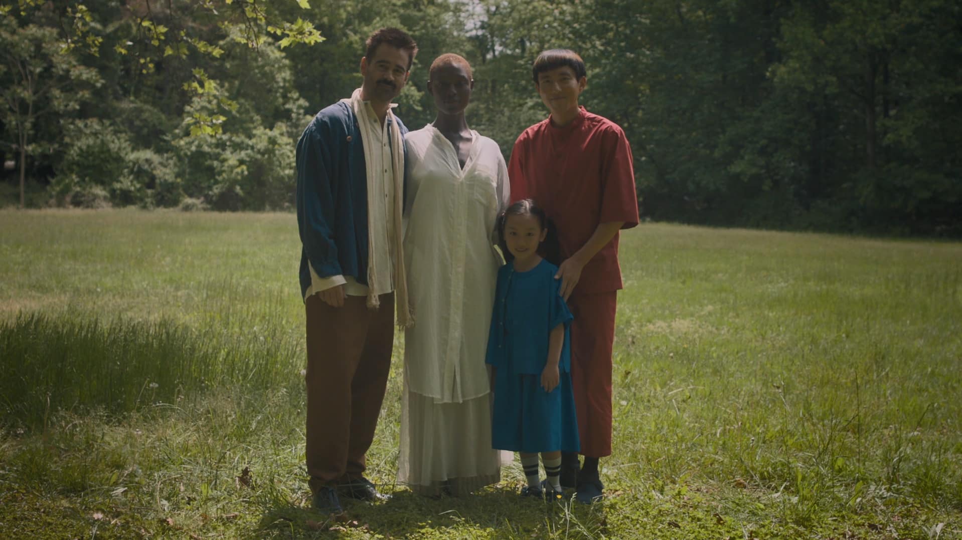 Techno-sapien Yang (right) sets a camera timer to take a photo of his foster family, then moves into frame with the rest of them (father Jake, mother Kyra, and daughter Mika), all smiling.