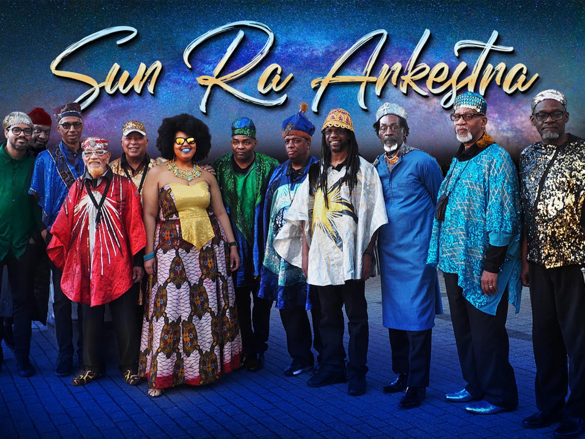 A publicity photo shows 12 members of the Sun Ra Arkestra posing in colorful clothes against a blue background.