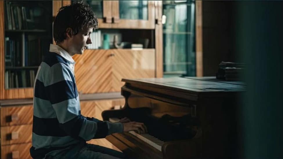 Grzegorz Płonka (Michal Sikorski) plays the piano in his father’s study.