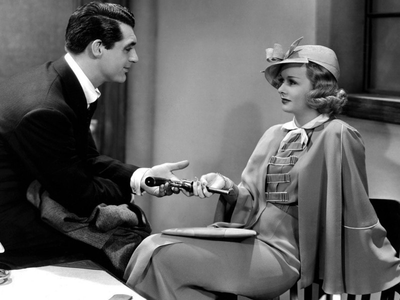 Eve Fallon (Joan Bennett) hands detective Danny Barr (Cary Grant) his gun back. Both coquettishly smile at one another.