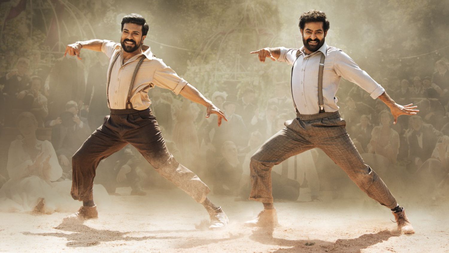 Rama Raju (Ram Charan) and Komaram Bheem (NTR Jr.) smile while in the midst of a choreographed dance move.