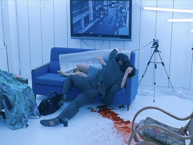 In a white room lit by fluorescent lights, Tae-Ju (Kim Ok-bin) feeds on an unsuspecting victim while her paralyzed mother-in-law (Kim Hae-sook) watches to their left.