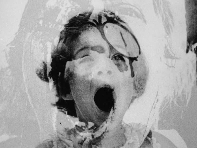 A photo of Caroline Kennedy as a child is layered with an image of a child wounded during the Vietnam War in Paolo Gioli's "Children" (2008).