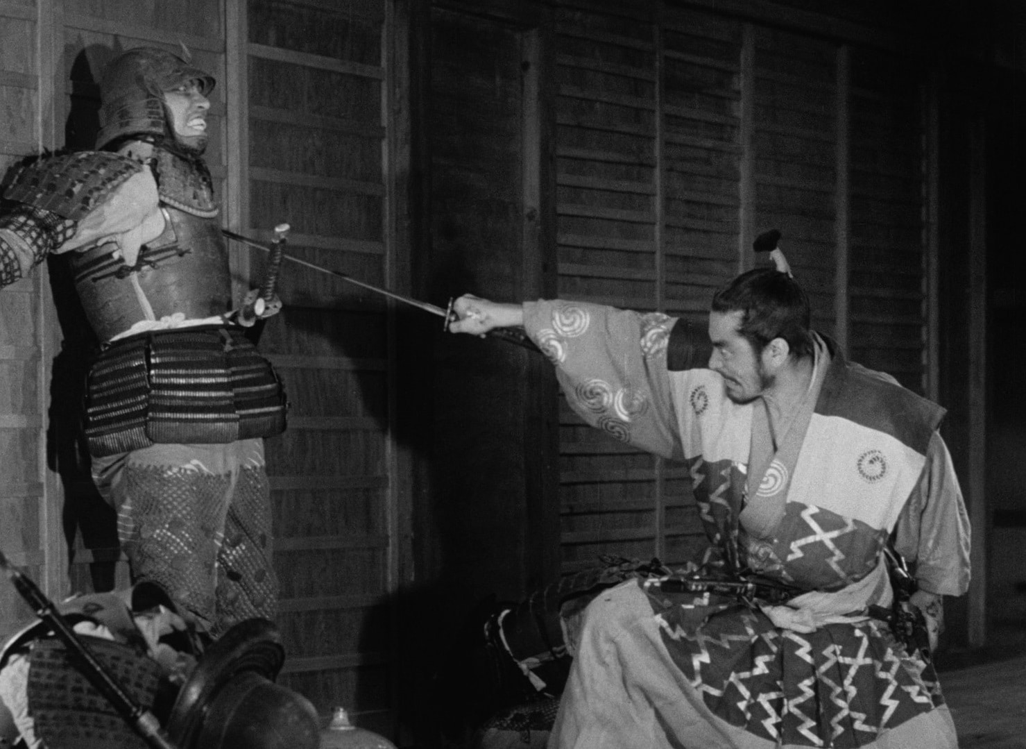 Samurai warrior Taketoki Washizu (Toshiro Mifune) brutally murders an innocent castle guard (Takeshi Kato) with his sword after assassinating his lord in his sleep.