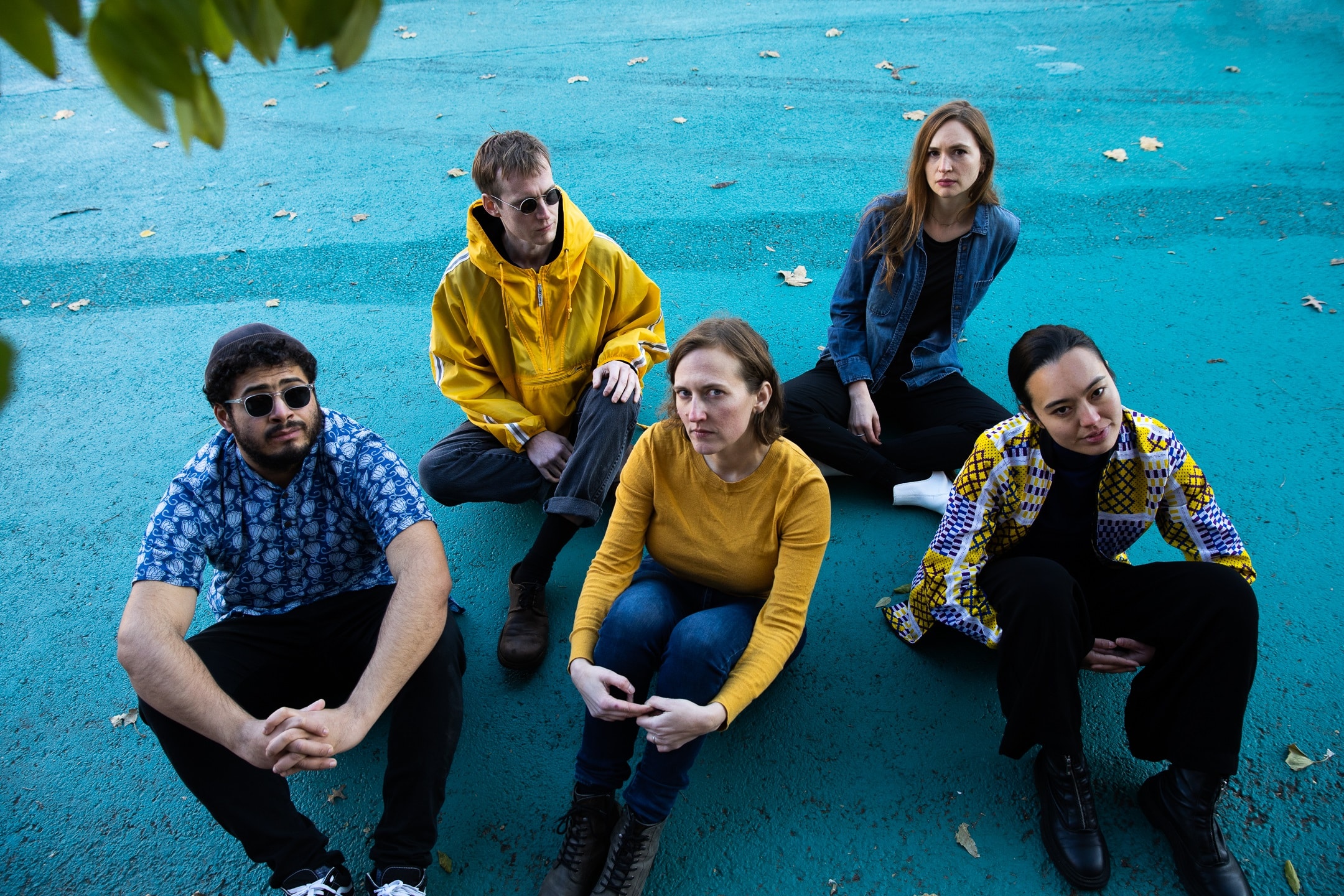 Shimmer Wince poses for a group photo (taken by Alice Plati) with a yellow and blue color palette. From L to R: Adam O'Farrill, Elias Stemeseder, Anna Webber, Mariel Roberts, and Lesley Mok.