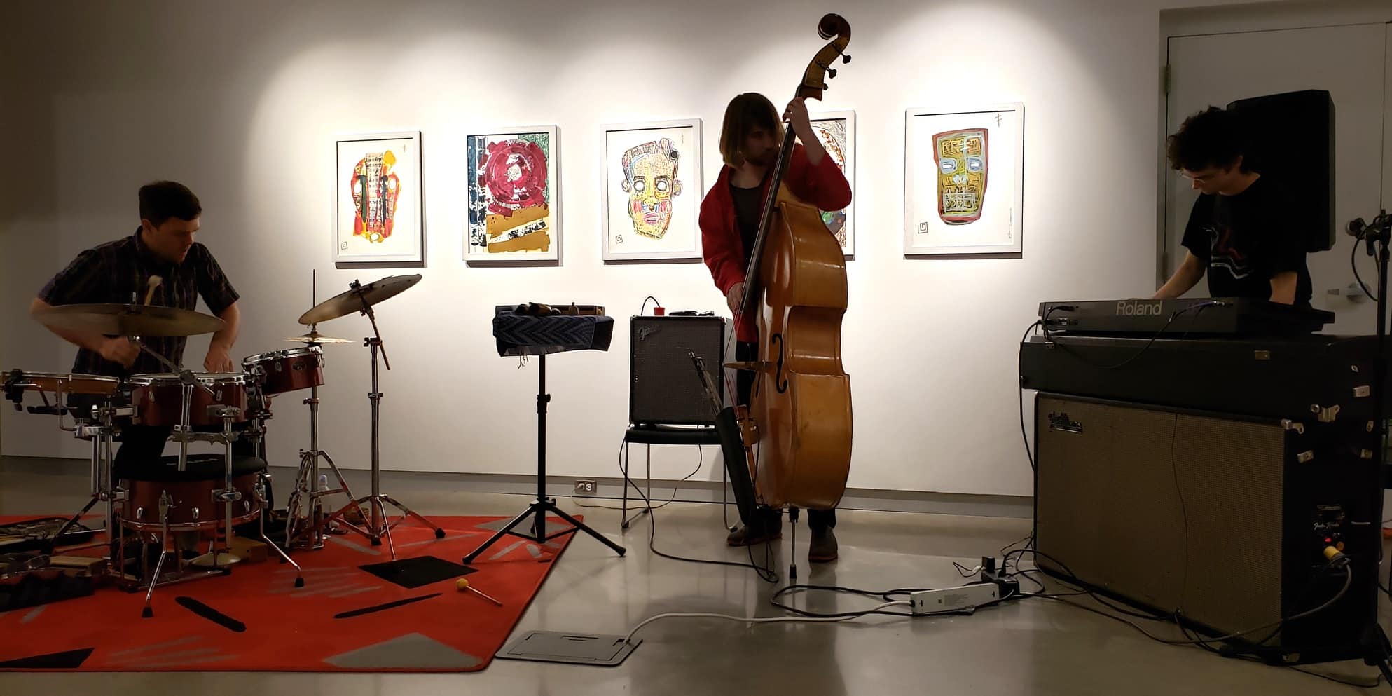 In a mood-lit gallery space, Laminal Animil (L to R: Tim Russell, Ari Smith, and Luke Leavitt) improvise in June 2022. Photo at Arts + Literature Laboratory by Grant Phipps.