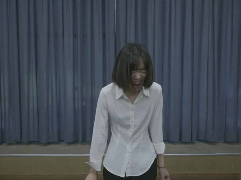 After introducing herself to the casting director, actor Yuying Tang, dressed in a white button-down shirt, "screams" the part of a humanoid robotic servant.