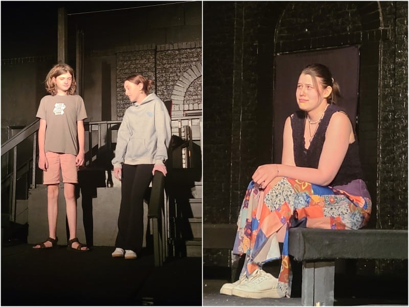 A basic landscape-oriented collage is split vertically between two photos of teenage actors on a basic black-painted rehearsal stage. They are all dressed in casual clothes, not character costumes. On the left, at a medium shot, two actors stand and partly face one another mid-conversation while leaning near a railing by some steps. On the right, at a close-up, a female actor sits on the edge of the stage with a pained, upset expression. She looks off to the left.