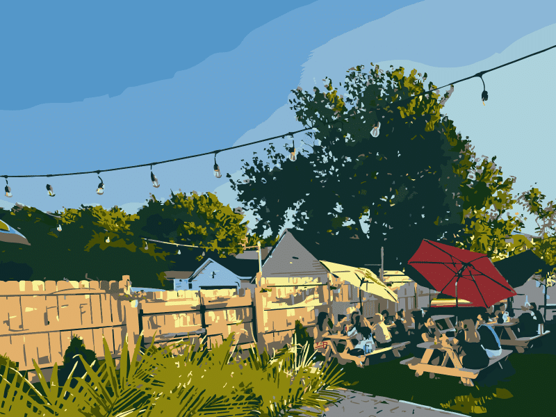 A photo modified with an impressionistic filter of an outdoor seating area at a pub. Several people sit at picnic tables under colorful umbrellas and a bright blue sky. A wooden fence divides the outdoor pub area from neighboring houses on the other side.