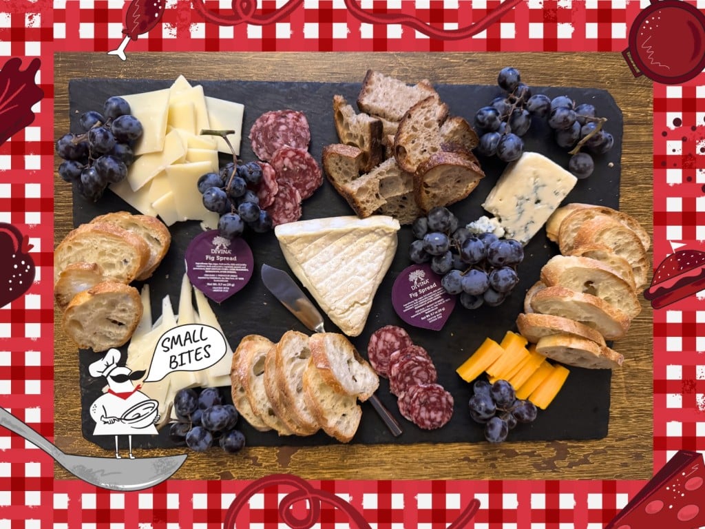 A close-up photo of the author's cheeseboard. It contains snacking portions of (baguette) bread, cured meat, soft and blue cheeses, grape clusters, and fig spread in small packaged containers all carefully arranged. Bordering this photo is a red and white checkered tablecloth illustration. In the lower left corner of this illustrated frame is a small chef with an oversized mustache standing on a spoon. The chef's speech bubble reads "Small Bites."