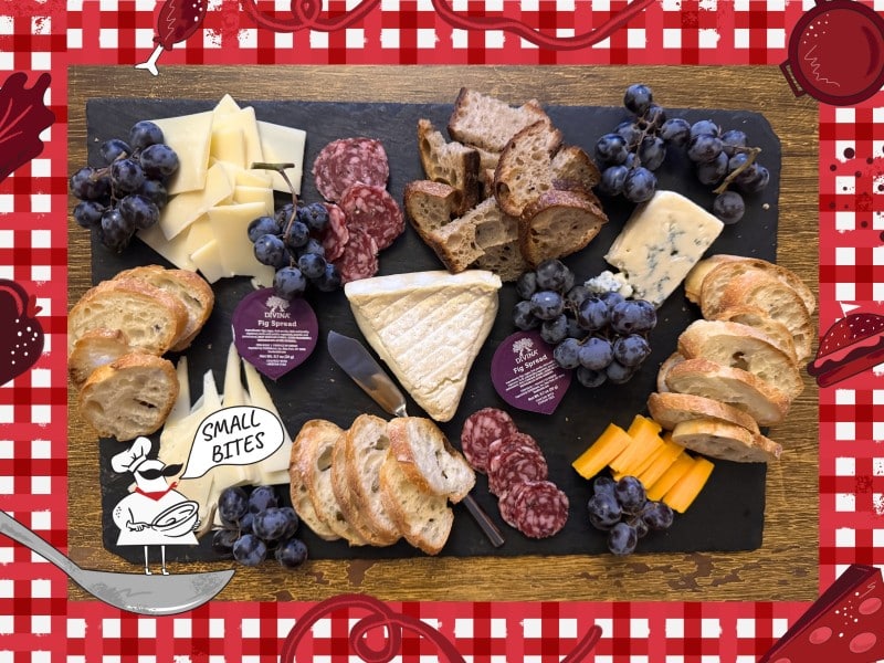 A close-up photo of the author's cheeseboard. It contains snacking portions of (baguette) bread, cured meat, soft and blue cheeses, grape clusters, and fig spread in small packaged containers all carefully arranged. Bordering this photo is a red and white checkered tablecloth illustration. In the lower left corner of this illustrated frame is a small chef with an oversized mustache standing on a spoon. The chef's speech bubble reads "Small Bites."