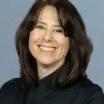 Headshot of a white woman with brown hair.