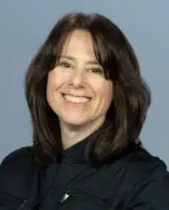Headshot of a white woman with brown hair.