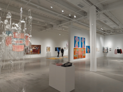 Photo of a museum gallery with several works of art on display.