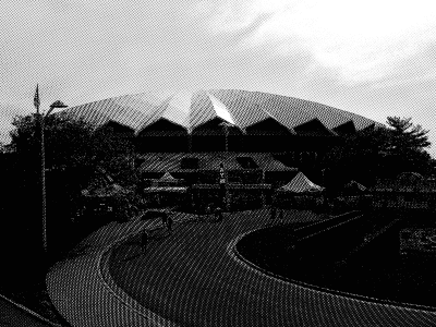 A photo of a winding road leading up to the Alliant Energy Center in Madison, Wisconsin, with a heavy, obfuscating black-and-white filter applied.