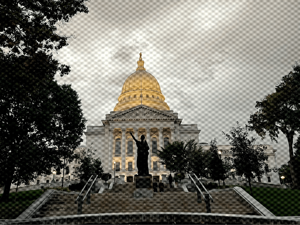Photo of the Wisconsin Capitol with the "Forward" statue on the stairs. Image has been desaturated except the yellow of the dome. A mesh screen filter has also been added.