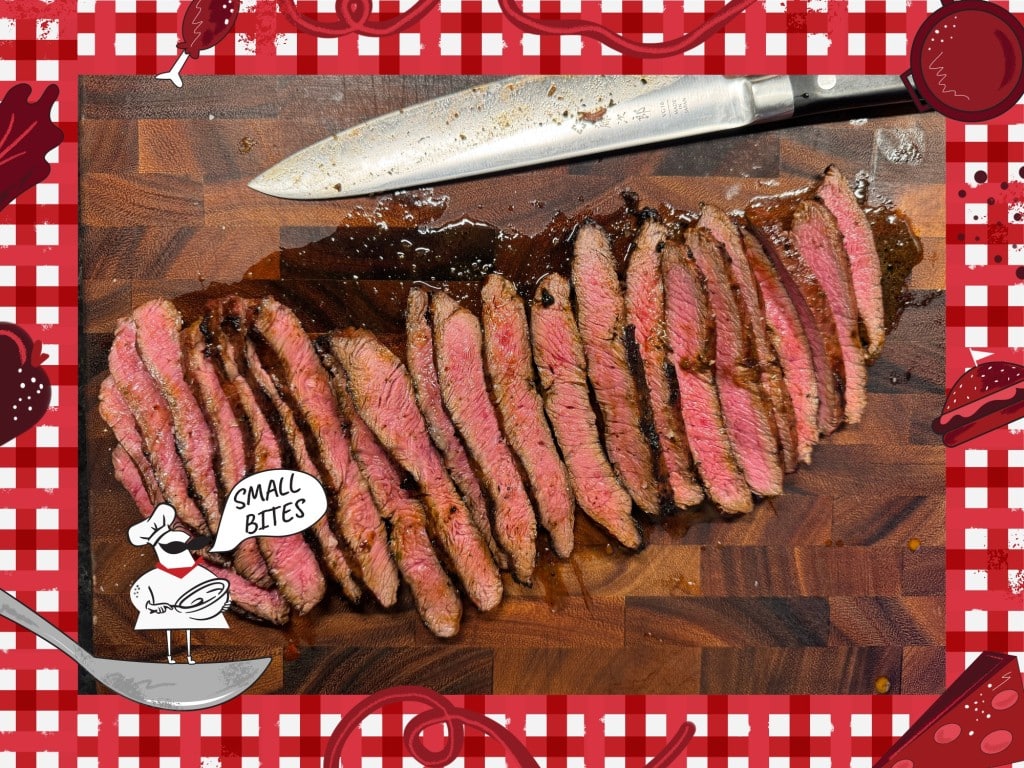 Photo of slenderly sliced pieces of medium-done steak sitting on a wooden cutting board. A kitchen knife sits on the board behind the steak with the blade facing away from the camera. Bordering this photo is a red and white checkered tablecloth illustration. In the lower left corner of this illustrated frame is a small chef with an oversized mustache standing on a spoon. The chef's speech bubble reads "Small Bites."