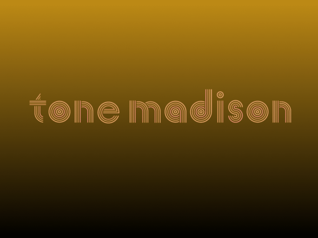 The "tone madison" logo in all lowercase, centered in the concentric-circle font face designed by Shelby Floyd, on a metallic bronze-colored gradient background that gradually turns to the color black from top to bottom.