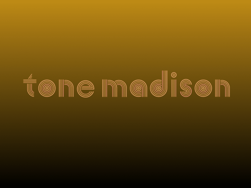 The "tone madison" logo in all lowercase, centered in the concentric-circle font face designed by Shelby Floyd, on a metallic bronze-colored gradient background that gradually turns to the color black from top to bottom.